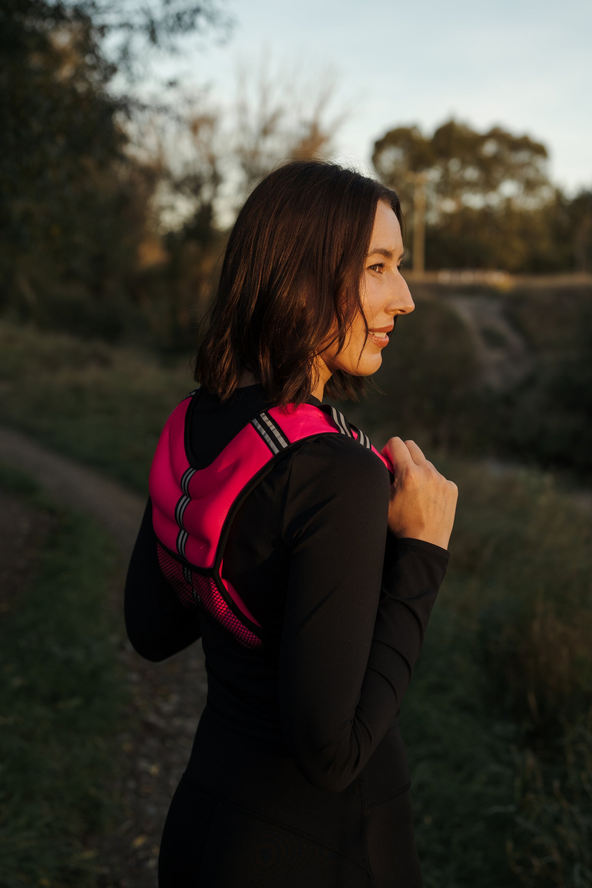 3/4 Rear view of a lady exercising in the VestFit NZ pink weighted neoprene vest